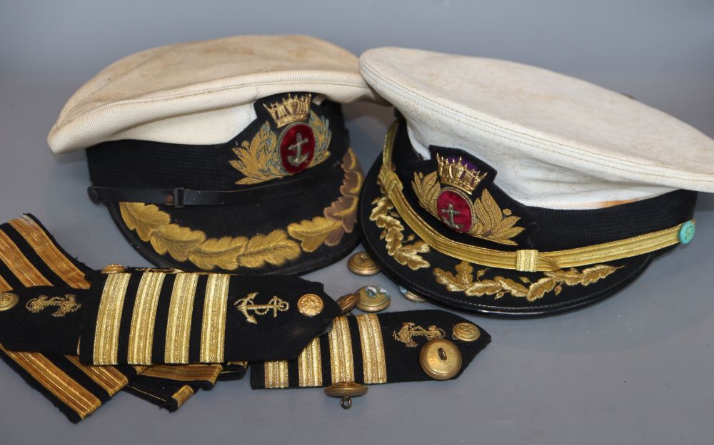Two Naval caps, together with buttons and epaulettes